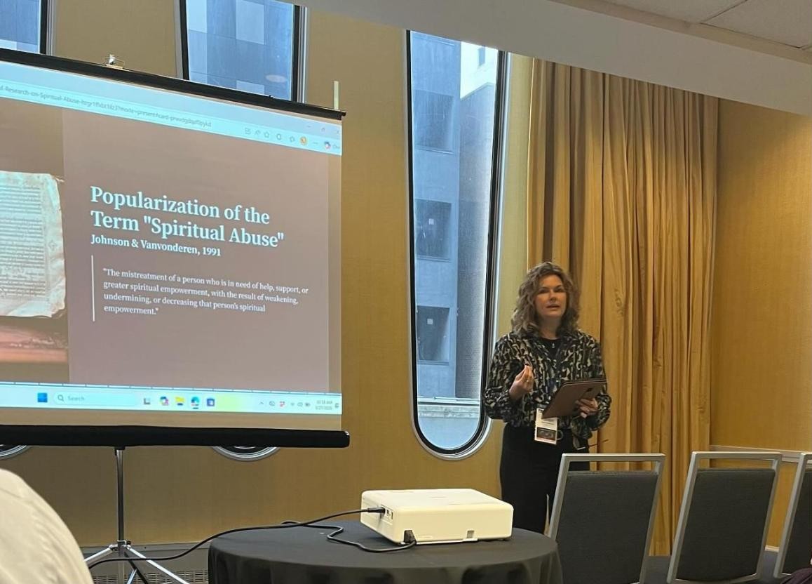 Karen presenting research on spiritual abuse at a conference